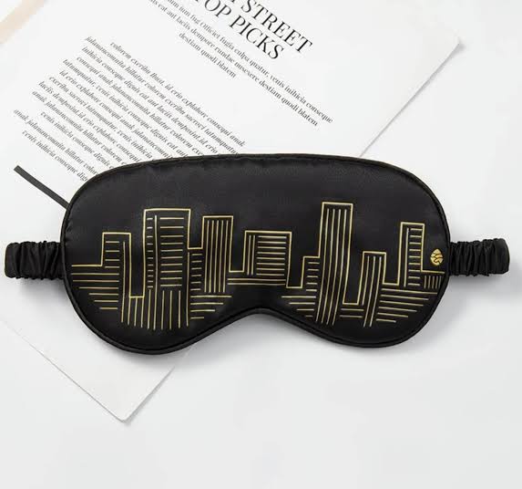 Soft black custom sleeping mask by Yourstuffmade.com with adjustable strap, designed for comfort and light blocking during sleep.