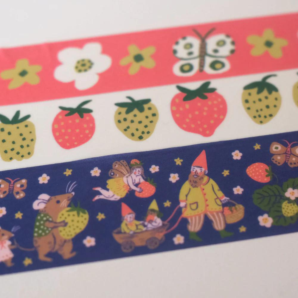 washi tape roll with flowers, strawberries, and gnome print on it