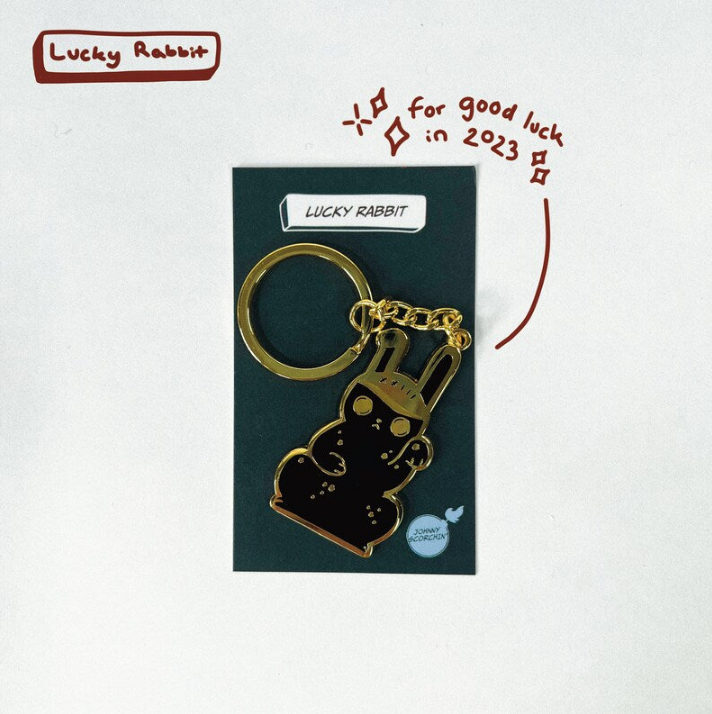 Gold keychain in a backing card with "LUCKY RABBIT" text