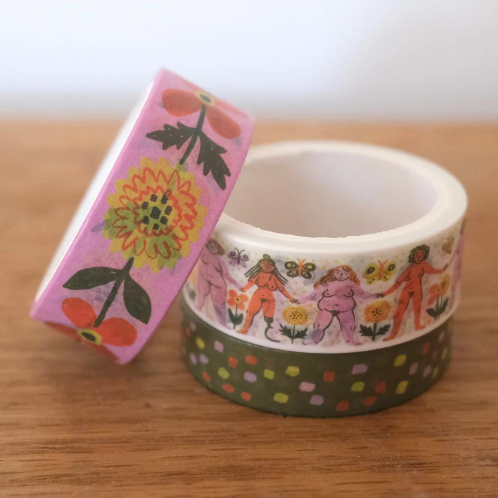 washi tape roll with flowers, dots, and female body print on it