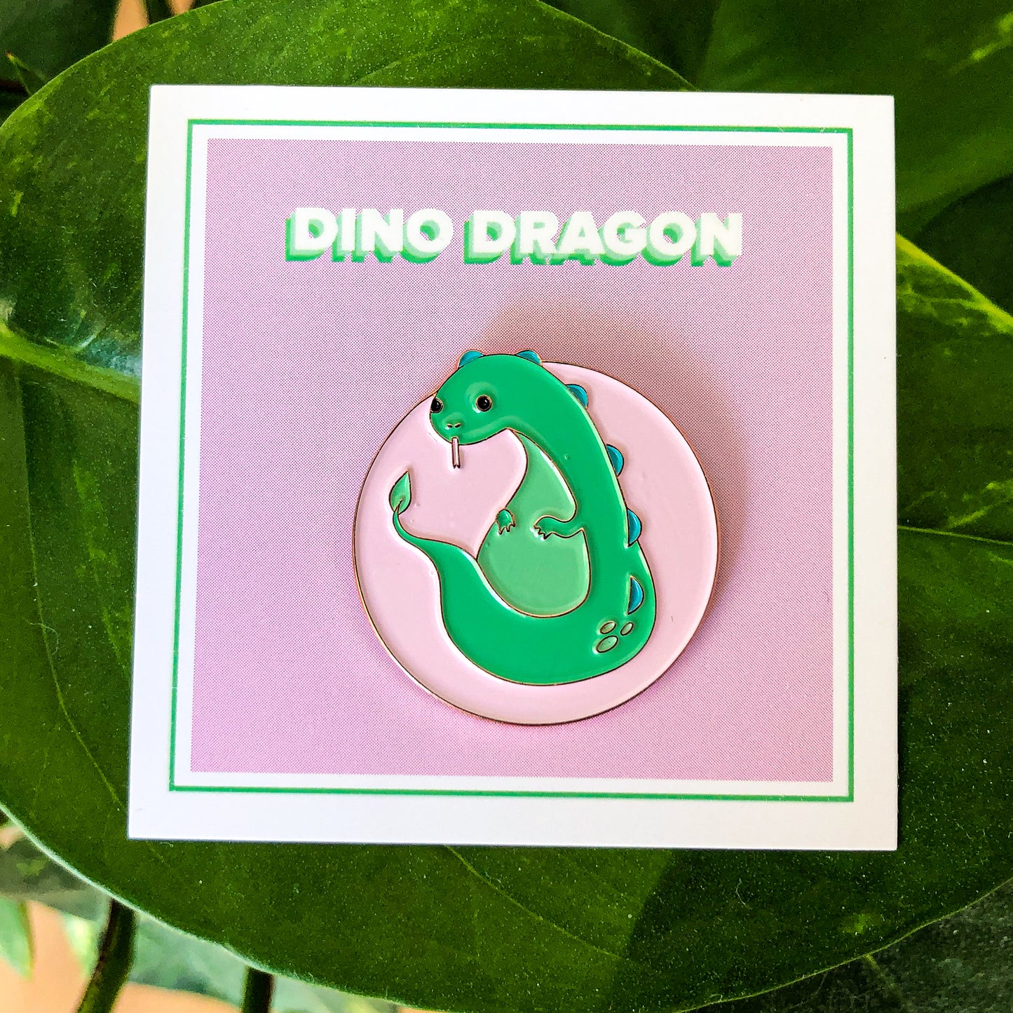 Green Dragon Soft Enamel Pin on Pink Backing Card with "DINO DRAGON" Text