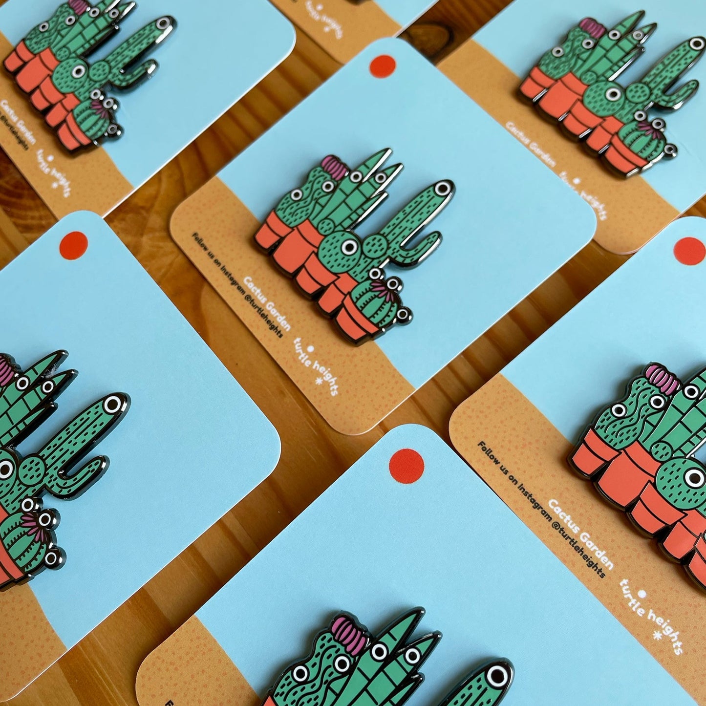 Cactus Garden Hard Enamel Pin on Backing Card with "Turtle Heights" Text