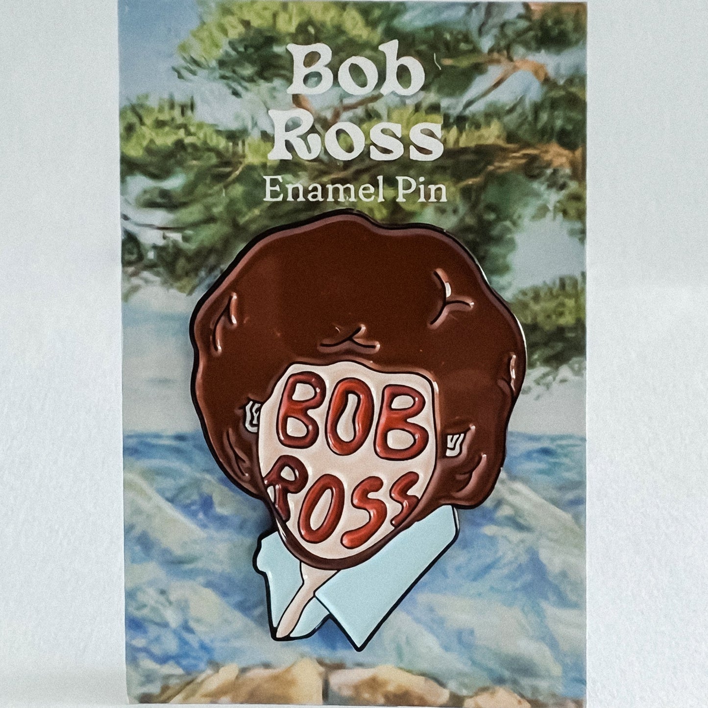 Soft Enamel Pin on Backing Card with "Bob Ross Enamel Pin" Text
