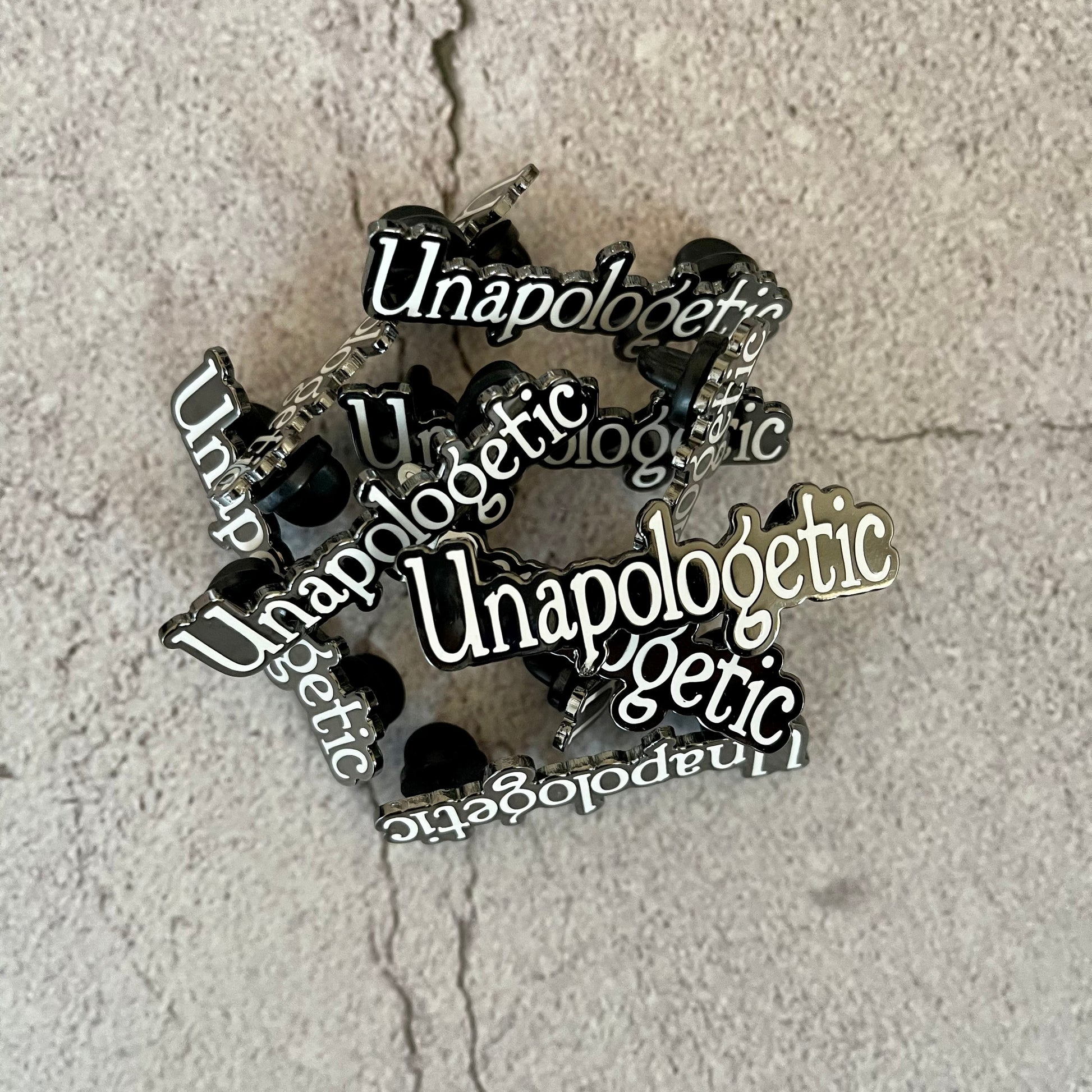 Hard Enamel Pin that says "Unapologetic"