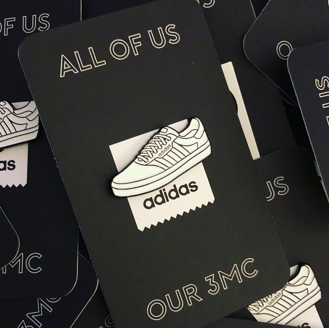 Adidas Enamel Pin on Black Backing Card with "ALL OF US, OUR 3MC" Text
