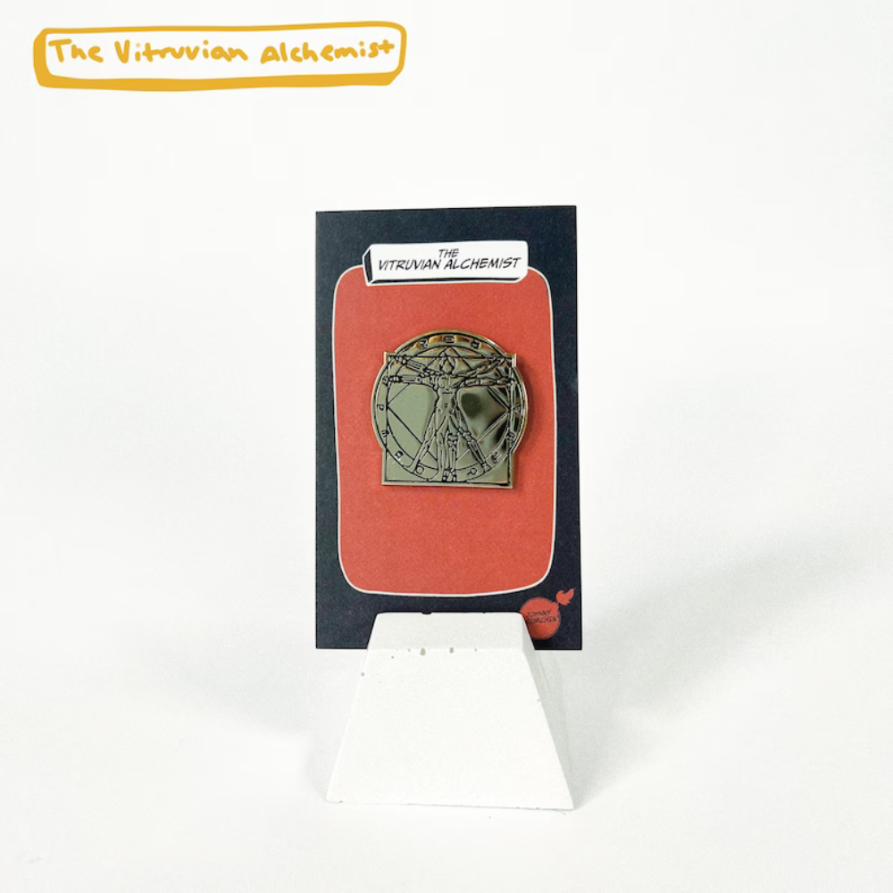 Enamel Pin on Backing Card with "THE VITRUVIAN ALCHEMIST" text