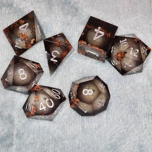 Colorful custom dice set with various numbered faces, designed for gaming or collection by Yourstuffmade.com.